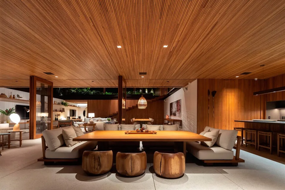 Wood ceiling extending over a furnished dining and living area