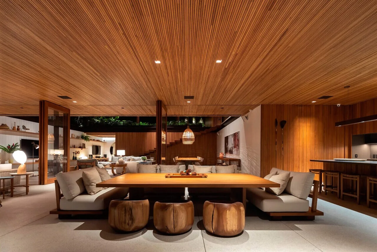 Wood ceiling extending over a furnished dining and living area