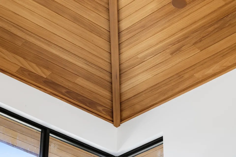 Close-up of wood ceiling boards meeting along a precise angled corner