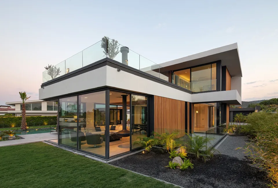 Contemporary home with wood cladding, full-height glass and a landscaped garden
