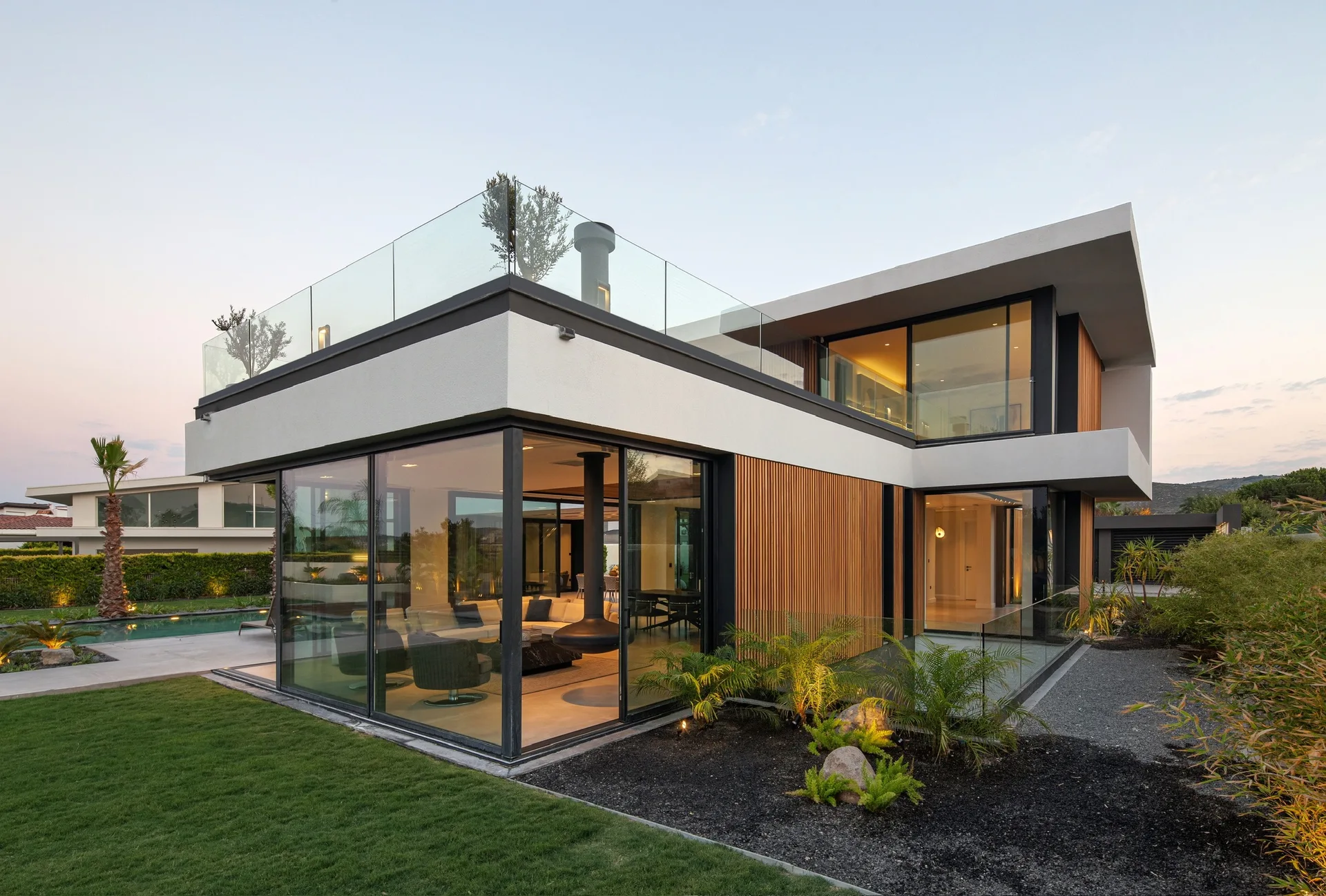 Contemporary home with wood cladding, full-height glass and a landscaped garden