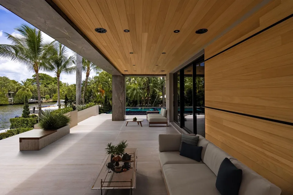 Long wood soffit above a sheltered terrace beside full-height glass and planting