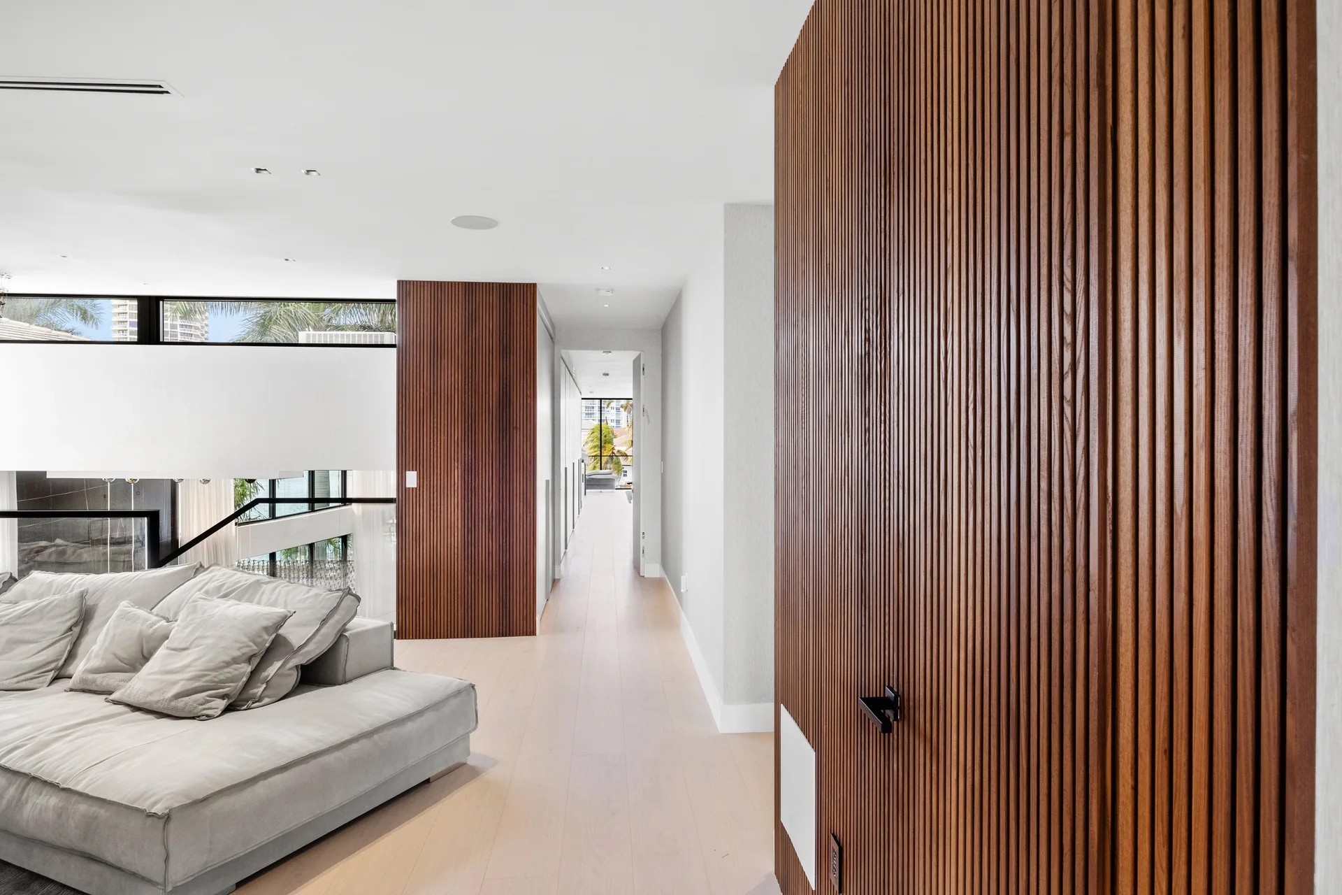 Vertical fluted wood lining and a flush door in a modern interior