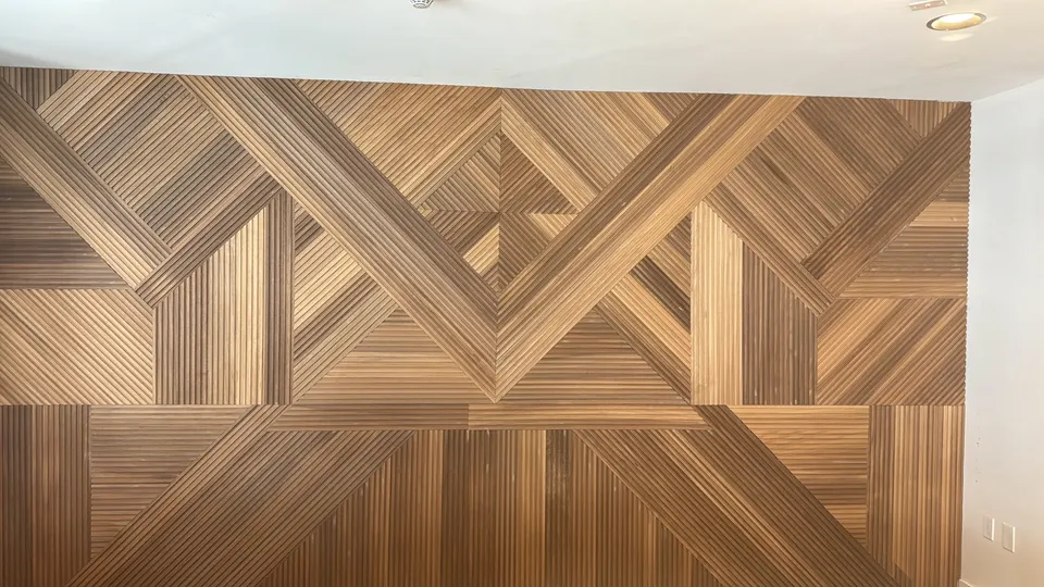 Geometric wood feature wall with diagonal and vertical board patterns