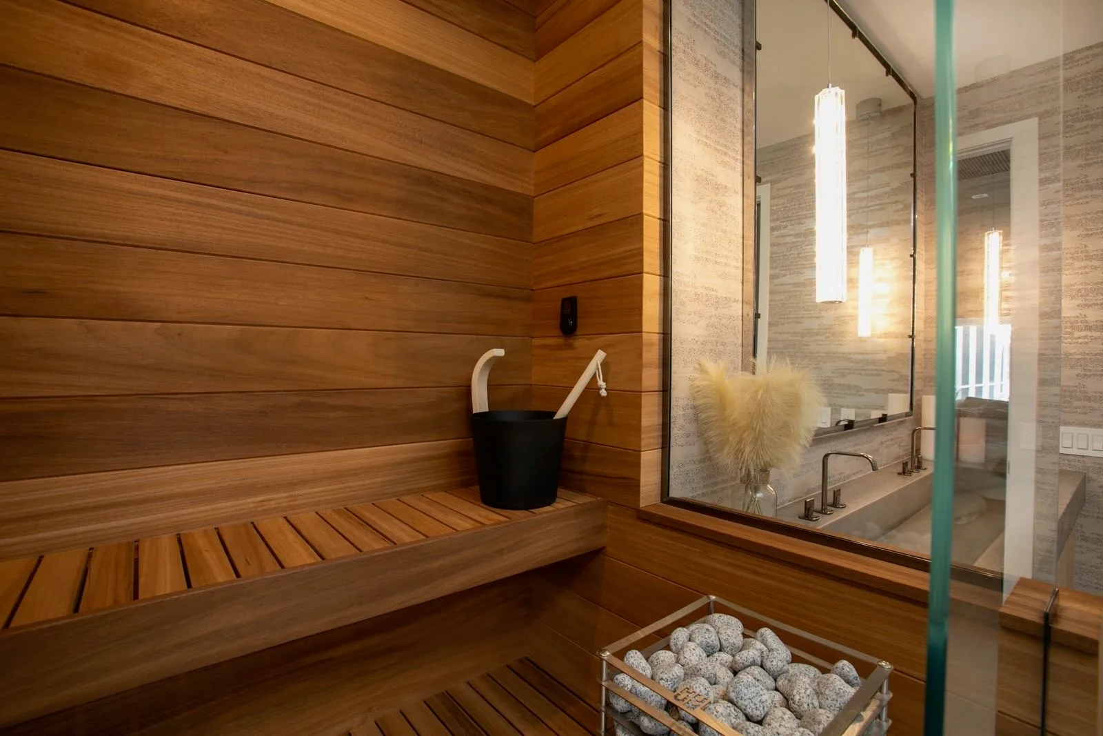 Wood-lined sauna with benches and a glazed wall from the Maximo sauna project album