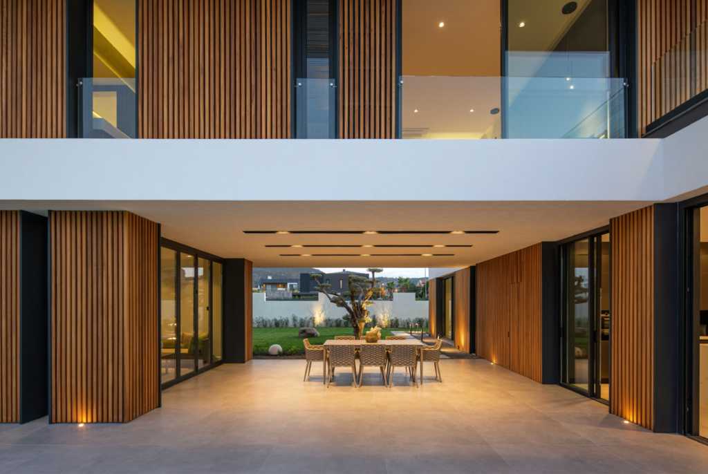 Thermally modified wood siding on the upper and lower levels of a modern home.