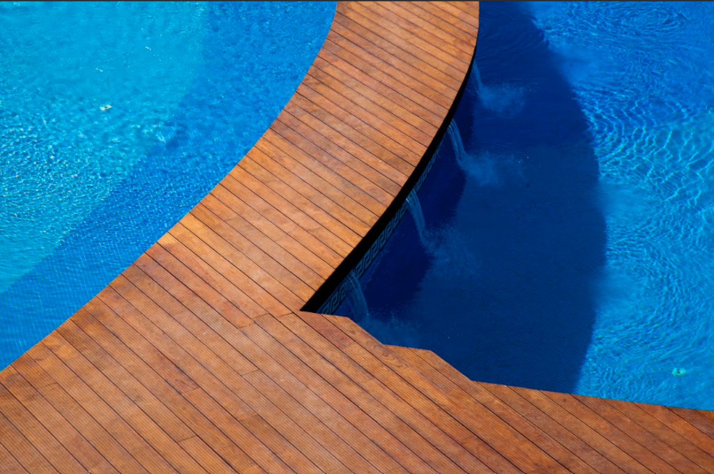 Novawood thermally modified ash wood decking spans a pool area.